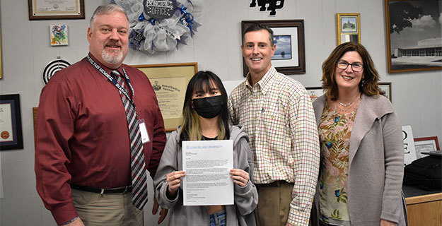 New Hyde Park Memorial High School senior Erika Dong With Staff Members Holding Award