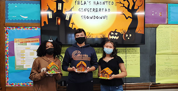 Students Holding Their Haunted Gingerbread Houses
