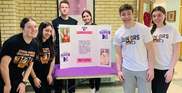 students standing around their poster