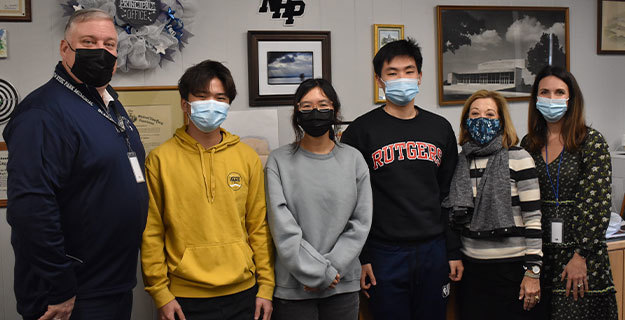 High School seniors Daniel Kim, Emma Ouyang and Laurence Lai and Staff