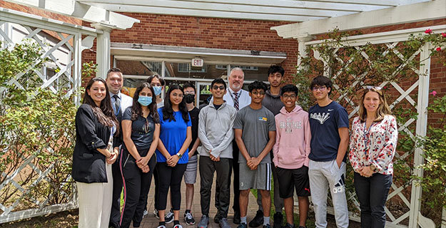 Students who earned the National Merit Scholarship Program standing outside