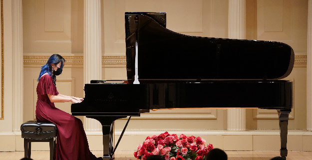 New Hyde Park Memorial High School junior Leilani Lee performing her Piano solo on stage at Carnegie Hall