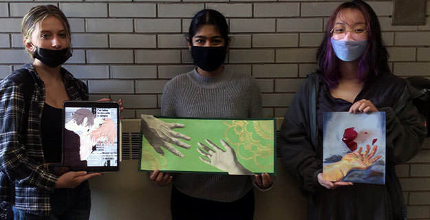 Students Holding Artwork