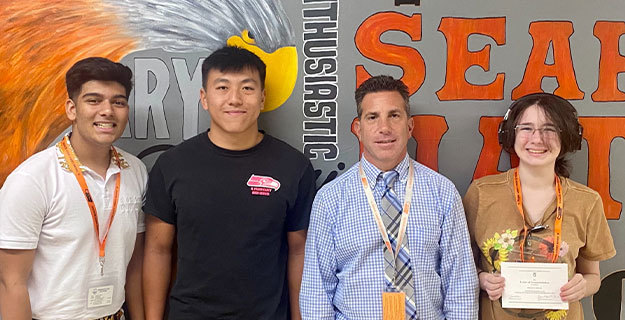Tyler Sookralli, Ryan Yu and Regan Nolan with teacher