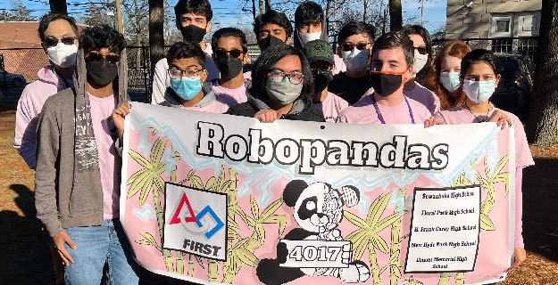 students holding robopandas banner 