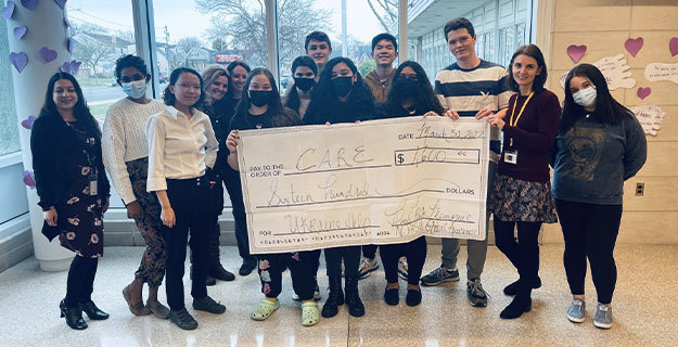 ​Floral Park Memorial High School’s Global Awareness Club and Junior High National Honor Society Holding Check