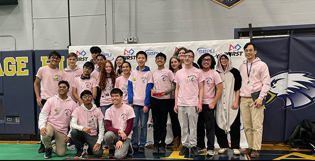 The district's robotics team smiling at the camera
