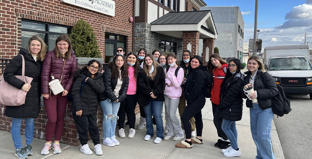 People standing outside of a brick building