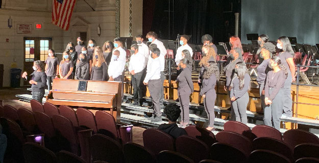 chorus performing on stage