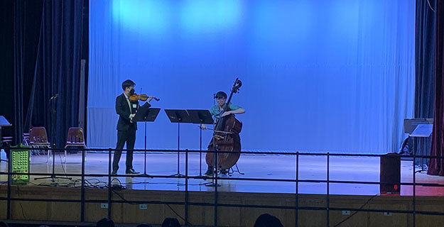 Two muscians playing on a stage