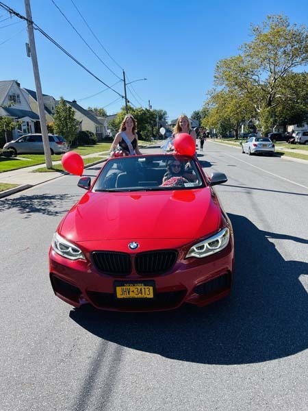  Kate Edwards and Julia Mills homecoming royalty in a red car