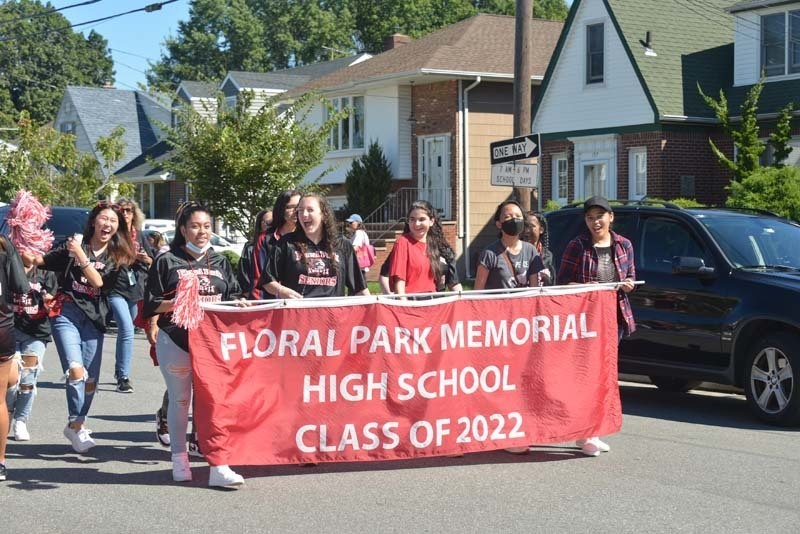 Floral park class holding a banner and marching in the street