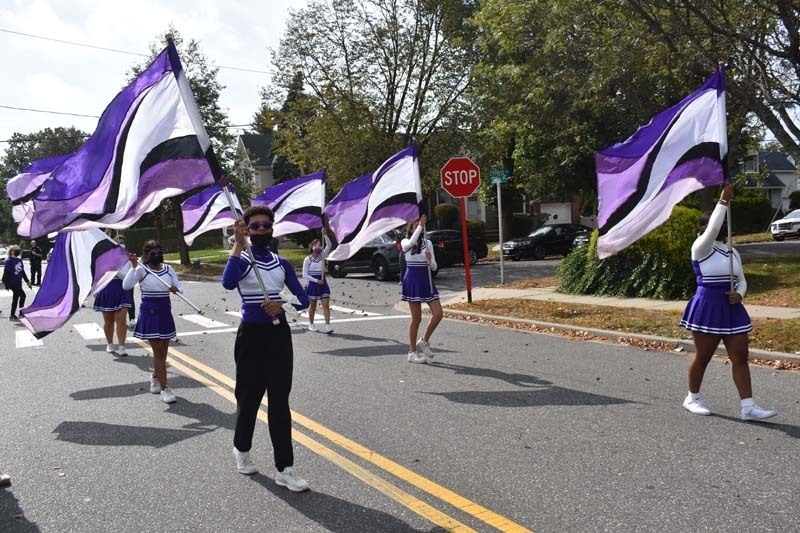 Cheerleaders Holding Flags During Parade