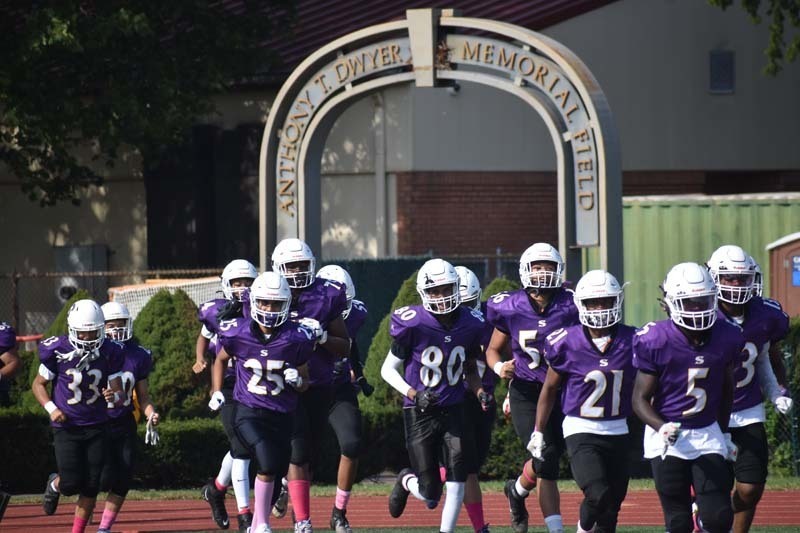 Football Players Running Out To Field