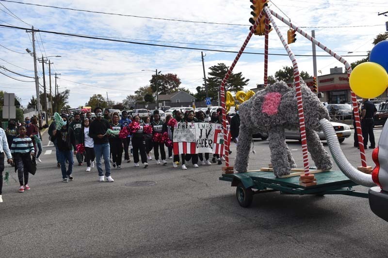 Students Walking With Floats During Parade