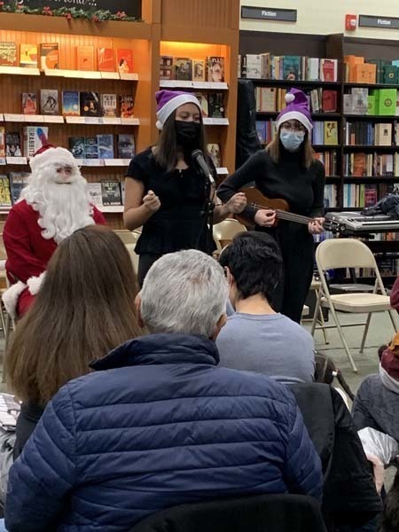 students performing a song with santa