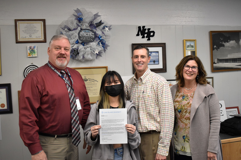 New Hyde Park Memorial High School senior Erika Dong With Staff Members Holding Award