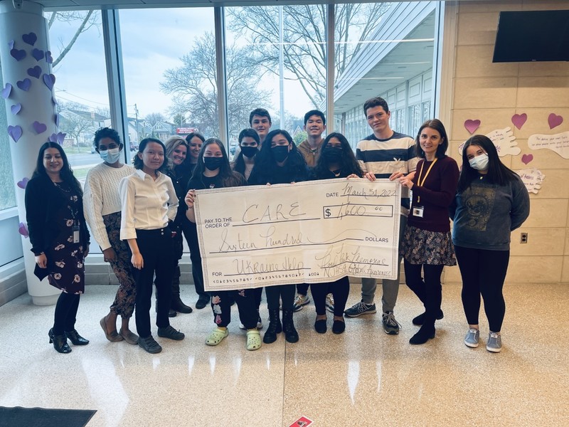 Floral Park Memorial High School’s Global Awareness Club and Junior High National Honor Society Holding Check