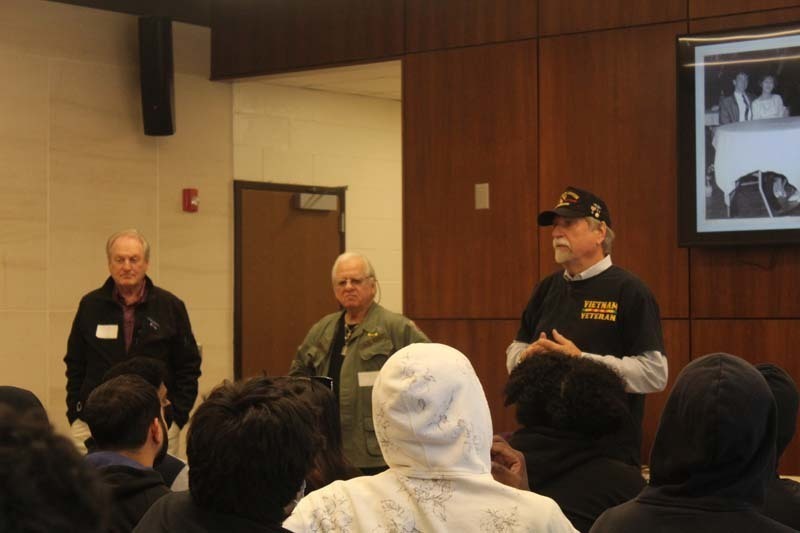 Three veterans talk with students