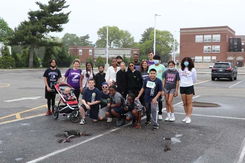 Students standing in a parking lot for a group photo