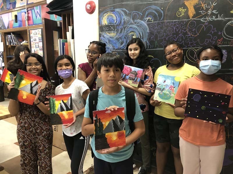Students with their artwork
