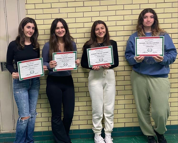 Four students holding certificates