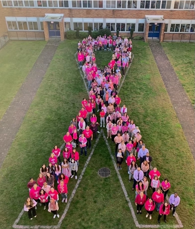 Students in the Shape of a Pink Ribbon