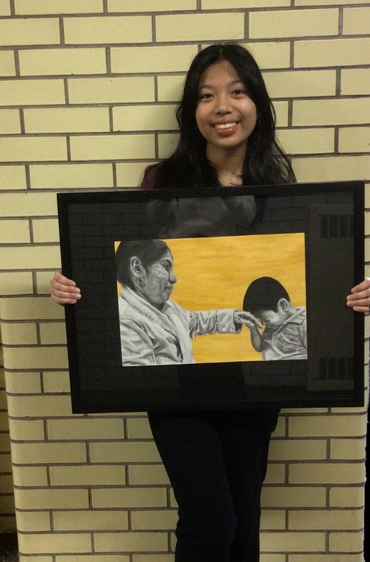 Floral Park Memorial High School 12th grader Shanelle Tangonan Holding Artwork