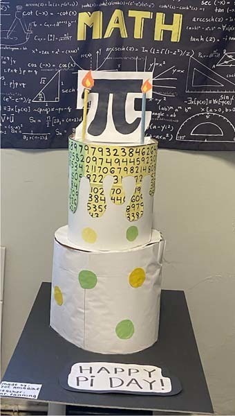 A paper cake with pi on top