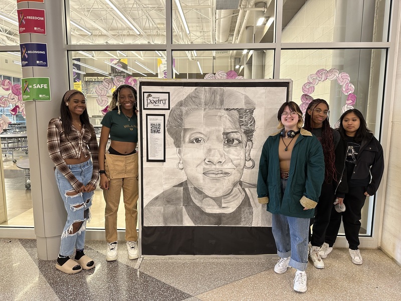 Students stand with Maya Angelou Portrait