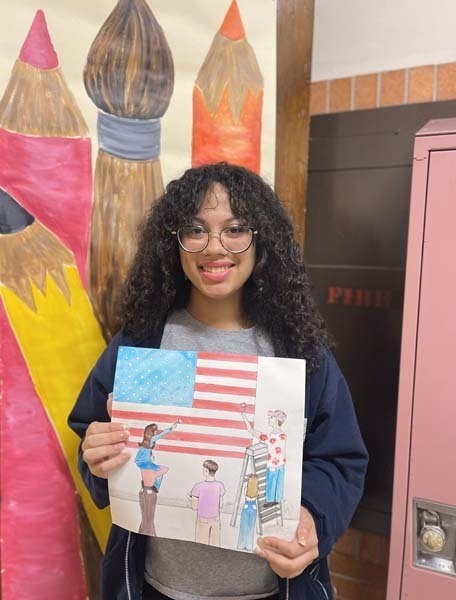 Student Chanely Herrera holding drawing